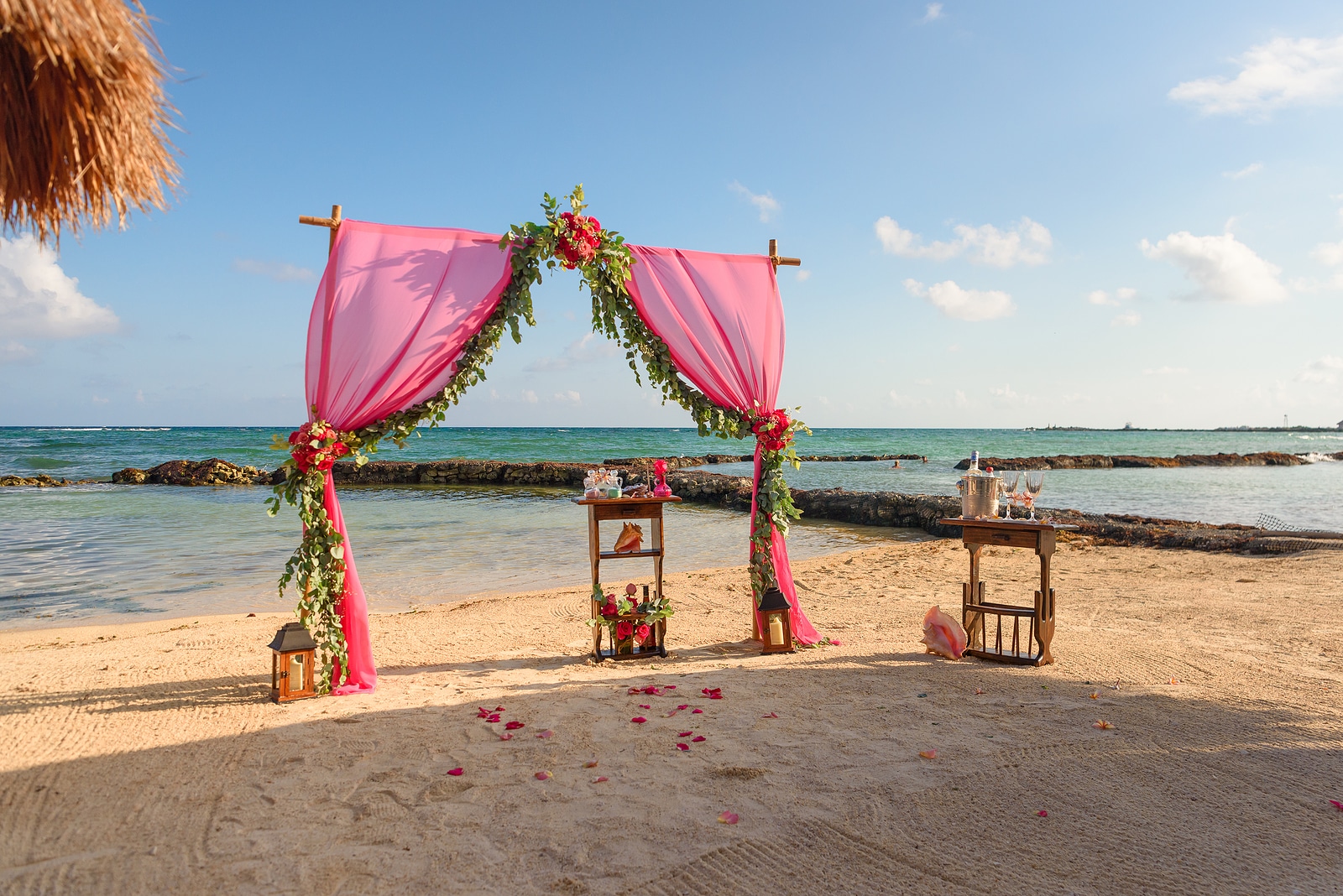 Wedding arch on the beach and a tropical beach. by Astuto Travel